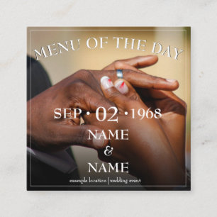 Hands of a wedding couple with a ring enclosure card