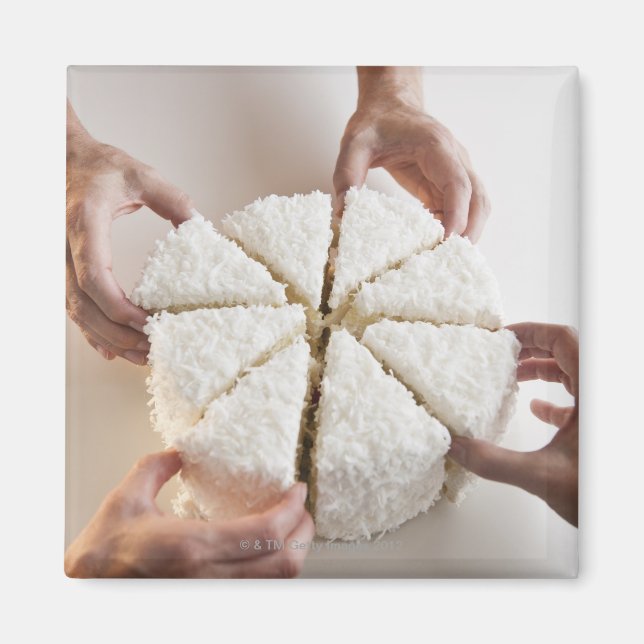 Hands pulling slices from cake magnet (Front)