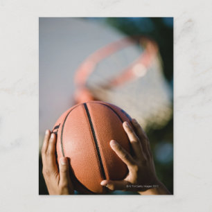 Hands shooting basketball outdoors postcard