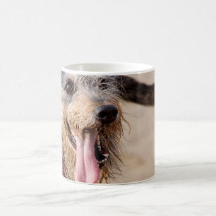 Happy dog on a beach coffee mug
