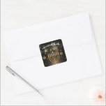 Happy Hanukkah Gold Star of David Menorah Black Square Sticker<br><div class="desc">Elevate your Hanukkah festivities with these chic Hanukkah stickers! With a sleek design featuring a radiant gold Star of David and Menorah set against a sophisticated black background, these stickers are perfect for decorating gifts, cards, envelopes, and add a touch of elegance to your holiday celebrations. Perfect for embellishing invitations,...</div>