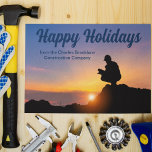 Happy Holidays Custom Construction Company Sunset Postcard<br><div class="desc">A construction worker crouches in front of a beautiful sunset on this lovely Happy Holidays postcard. A cute personalised construction company or home builder business Christmas postcard.</div>