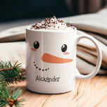 Happy Snowman Face Personalised Christmas Mug<br><div class="desc">Bring joy to chilly mornings with this adorable snowman face mug,  complete with a cheerful carrot nose,  blushing cheeks,  and your child's name printed below. It’s the perfect custom holiday gift for kids,  cocoa lovers,  or anyone who adores whimsical winter decor. Great for stocking stuffers and Christmas Eve traditions!</div>