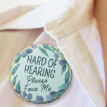 Hard of Hearing Please Face Me Blue Leaves 6 Cm Round Badge<br><div class="desc">Let people know your special needs with this botanical badge by JessicaAmber! Features the slogan 'Hard of Hearing, Please Face Me', surrounded by a wreath of blue leaves, on a pale blue background. You can edit the text and background colour as needed. ⭐ For more useful physical health accessories, visit...</div>