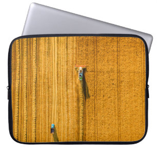 Harvester machine working in field. Combine harves Laptop Sleeve
