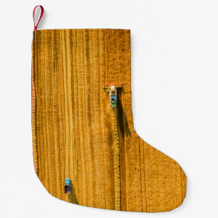 Harvester machine working in field. Combine harves Small Christmas Stocking
