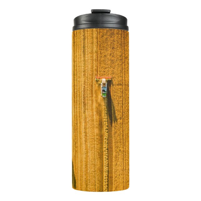 Harvester machine working in field. Combine harves Thermal Tumbler (Front)