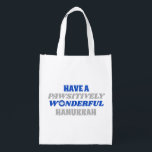 Have a Pawsitively Wonderful Hanukkah Reusable Grocery Bag<br><div class="desc">This delightful design showcases the heartfelt text "Have a pawsitively wonderful Hanukkah." The text is presented in blue and silver colours, with the letter "o" in "wonderful" playfully substituted with a paw print. This design captures the joy and celebration of Hanukkah with a pet-friendly twist. The combination of blue and...</div>