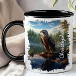 Hawk by Mountain Lake Reflection  Mug<br><div class="desc">Enjoy your favourite beverage with the Hawk by Mountain Lake Reflection Mug. This captivating mug features a detailed image of a hawk perched on a rock by a serene mountain lake, with the clear water reflecting the majestic bird and the surrounding wilderness. Customised with your name, it adds a unique...</div>