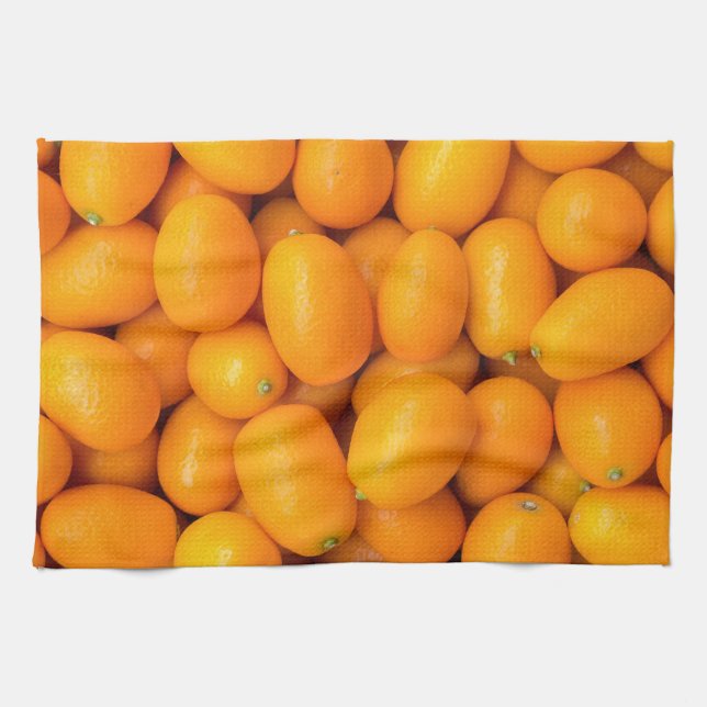 Heap of orange kumquats in cardboard box tea towel (Horizontal)