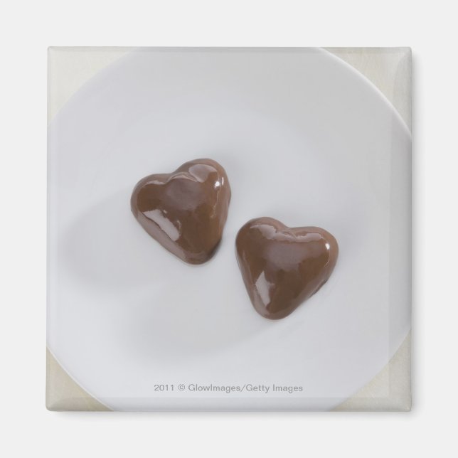 Heart shaped chocolate candies on a plate magnet (Front)