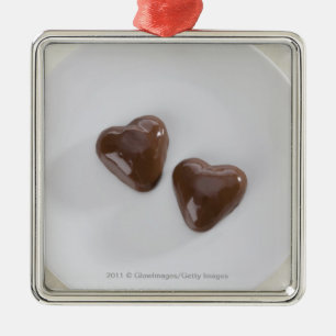 Heart shaped chocolate candies on a plate metal tree decoration
