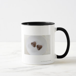 Heart shaped chocolate candies on a plate mug