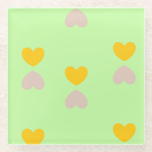 Hearts shapes on light green glass coaster