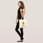 Heather Niemi Savage Logo Tote Bag<br><div class="desc">Support a composer by buying merch! Show off your love of music with a tote bag displaying my logo on a mint green background. My treble clef with a leaf logo in a dark sage green represents my work as both a musician and an herbalist. The 5 ripples represent the...</div>
