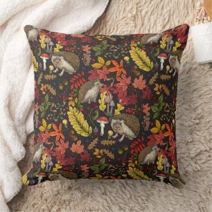 Hedgehogs and autumn forest flora on black cushion