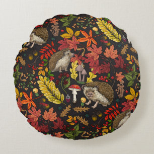 Hedgehogs and autumn forest flora on black round cushion