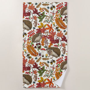 Hedgehogs and autumn forest flora on ivory beach towel