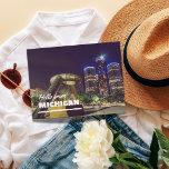 Hello From Michigan Postcard<br><div class="desc">Celebrate the vibrant essence of Michigan with our "Hello from Michigan" postcard. Featuring a captivating night view of the Renaissance Centre and the iconic Transcending Monument, this postcard captures the modern and historic charm of Detroit. Perfect for sharing your love for Michigan with friends and family, this high-quality postcard is...</div>