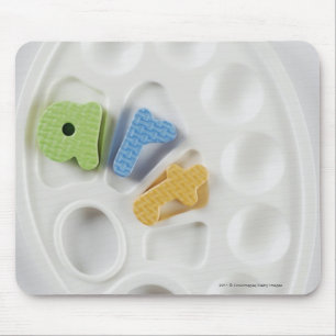 High angle view of alphabets on a palette mouse pad