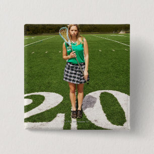 High school lacrosse player (16-18) holding 15 cm square badge