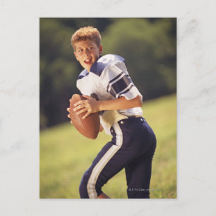 High school quarterback with football postcard