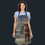 Highland cow calf autumn grass monogram initial apron<br><div class="desc">Highland cow calf autumn grass field photograph. Stunning young calf of highland scottish cattle on an autumn grassy field with muted colours. Beautiful dark hairy orange coat contrasting with light yellow green grass and trees in bokeh in background. Custom personalizable monogram with your name and inital on the left.</div>
