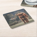 Highland cow calf autumn grass monogram initial square paper coaster<br><div class="desc">Highland cow calf autumn grass field photograph. Stunning young calf of highland scottish cattle on an autumn grassy field with muted colours. Beautiful dark hairy orange coat contrasting with light yellow green grass and trees in bokeh in background. Custom personalizable monogram with your name and inital on the left.</div>