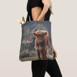 Highland cow calf autumn grass monogram initial tote bag<br><div class="desc">Highland cow calf autumn grass field photograph. Stunning young calf of highland scottish cattle on an autumn grassy field with muted colours. Beautiful dark hairy orange coat contrasting with light yellow green grass and trees in bokeh in background. Custom personalizable monogram with your name and inital on the left.</div>