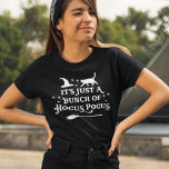 Hocus Pocus Halloween Quote Women's Black T-Shirt<br><div class="desc">Celebrate Halloween with this "It's just a bunch of Hocus Pocus" witch quote women's black graphic t-shirt. Decorative typography lettering is accented with spooky scrolls,  twinkling stars,  a witch hat,  cat,  and a witch's broomstick. White colour scheme and shirt colour can be modified.</div>