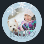 Holiday Photo Be Merry Christmas Blue Snowflakes Classic Round Sticker<br><div class="desc">The sticker has a placeholder for you to add your own photo. The typography is designed as a photo overlay and reads "Be Merry" in a modern font. You can further personalise the design by adding your family name(s). The sticker is powder blue with soft white, hand drawn snowflakes. Matching...</div>
