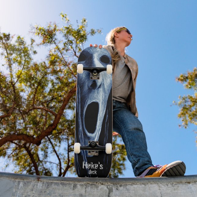 Hollow-eyed phantom witch etching on blue-black skateboard (Outdoor 1)