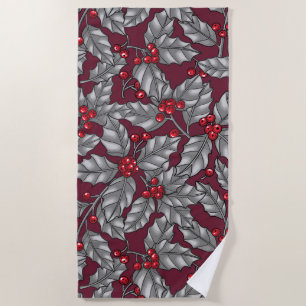 Holly berry, grey leaves on dark red beach towel