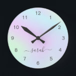 Holographic Girly Modern Elegant Script Name Round Clock<br><div class="desc">Modern wall clock featuring your name in an elegant handwritten script with swashes over a colourful holographic gradient in pastel pink,  purple,  blue and green. This stylish and feminine wall clock is great for a girly girl and makes a great gift for her.</div>