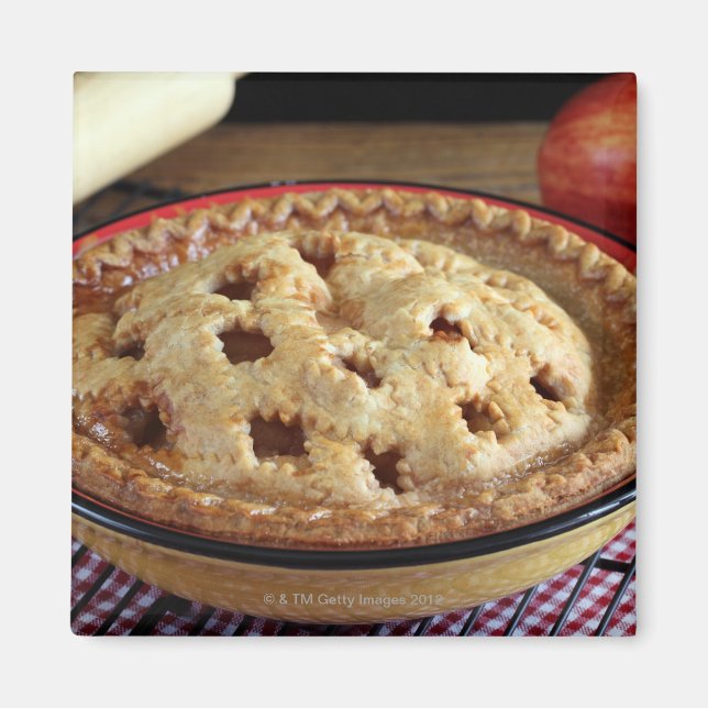Home baked apple pie on cooling rack with apple magnet (Front)