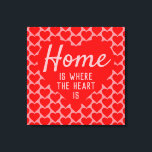 Home is Where The Heart Is Message Canvas Print<br><div class="desc">Home sweet home. An upbeat message that says "Home is Where The Heart Is". Red and Pink color theme with a large heart as the main motif. More smaller hearts form a patterned background.</div>