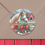 Horse at a Farm Christmas  Classic Round Sticker<br><div class="desc">A pretty amber brown and white horse behind a rustic wood fence with a festive wreath on it. In the background is an old rustic red barn.</div>