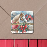Horse at a Farm Christmas  Square Sticker<br><div class="desc">A pretty amber brown and white horse behind a rustic wood fence with a festive wreath on it. In the background is an old rustic red barn.</div>