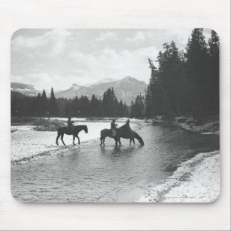 Horses drinking from and crossing a river mouse pad