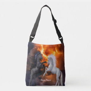Horses fighting in a bad lightning storm crossbody bag