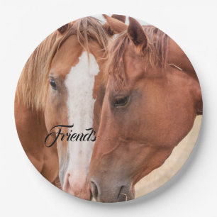 Horses nuzzling in a pasture paper plate