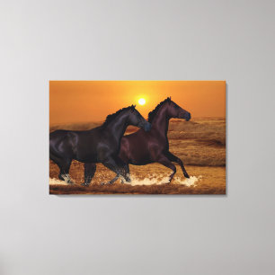 Horses running at ocean sunset canvas print