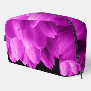 Hot pink flower petals on black dopp kit