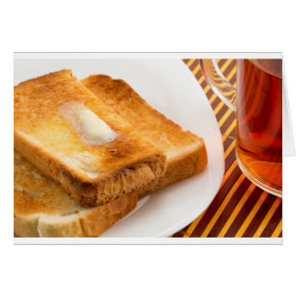 Hot toast with butter on a white plate