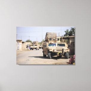 Humvee's conduct security during a patrol canvas print
