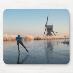 Ice skating past windmill and reeds mousepad