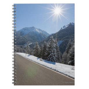 Idyllic empty road thrugh a winter landscape, 2 notebook