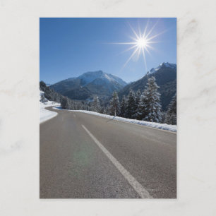 Idyllic empty road thrugh a winter landscape, postcard