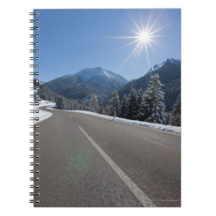 Idyllic empty road thrugh a winter landscape, spiral notebook