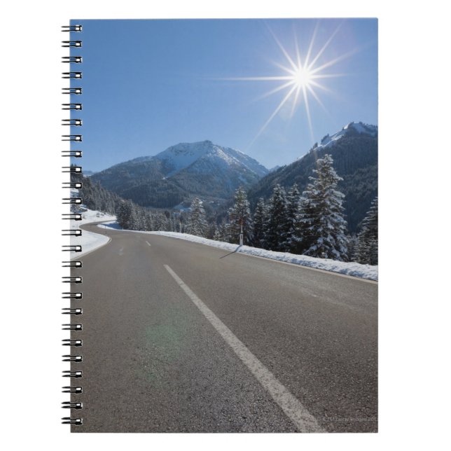 Idyllic empty road thrugh a winter landscape, spiral notebook (Front)